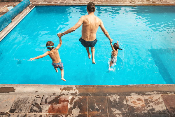 A family jumps into a pool A family jumps into a pool